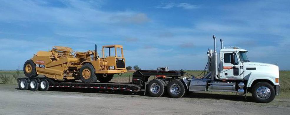 Diamond Eight lowboy hauling CAT scraper — South Texas